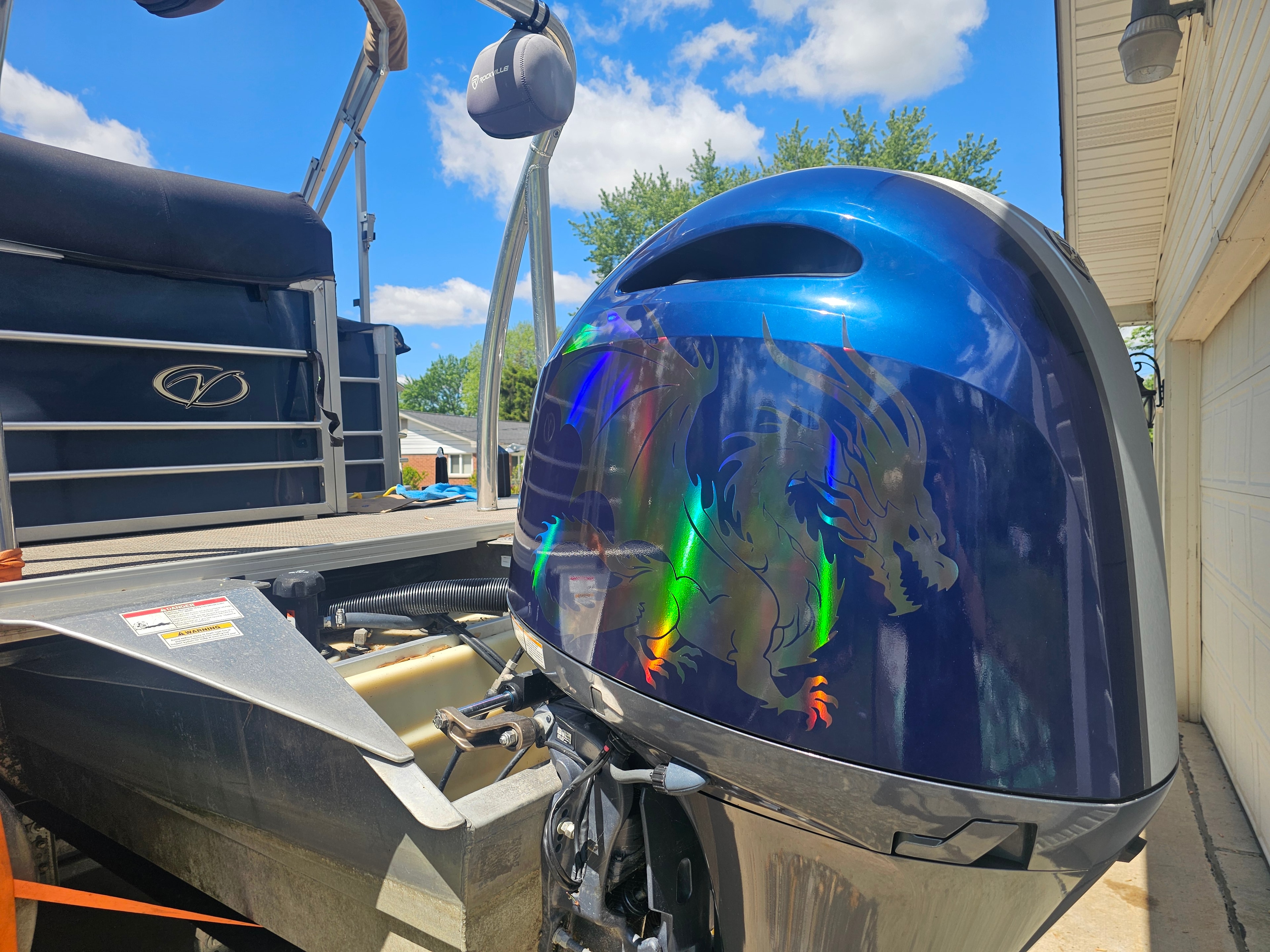 Custom blue boat motor graphics installation