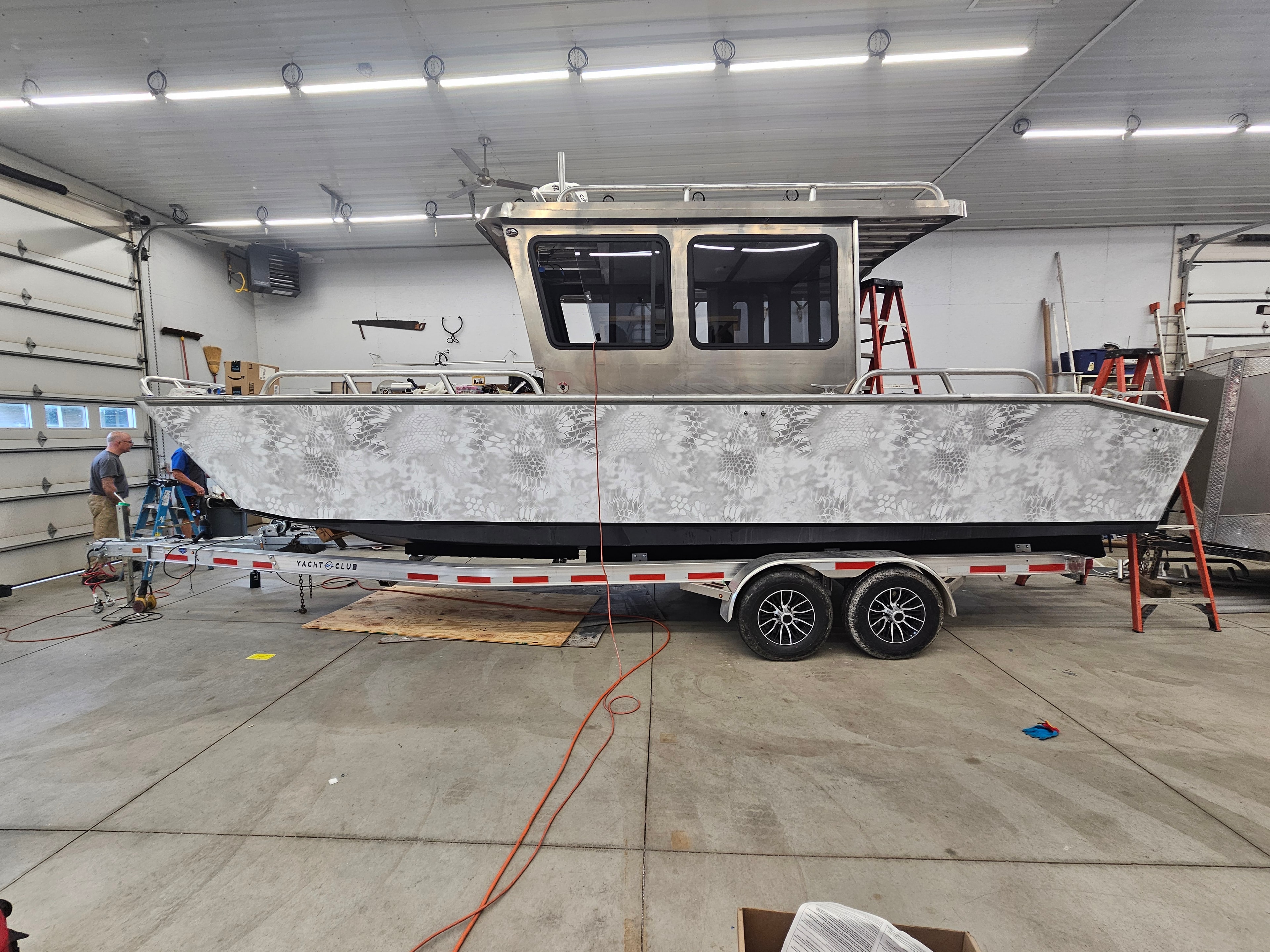 Side view of a custom camouflage boat wrap
