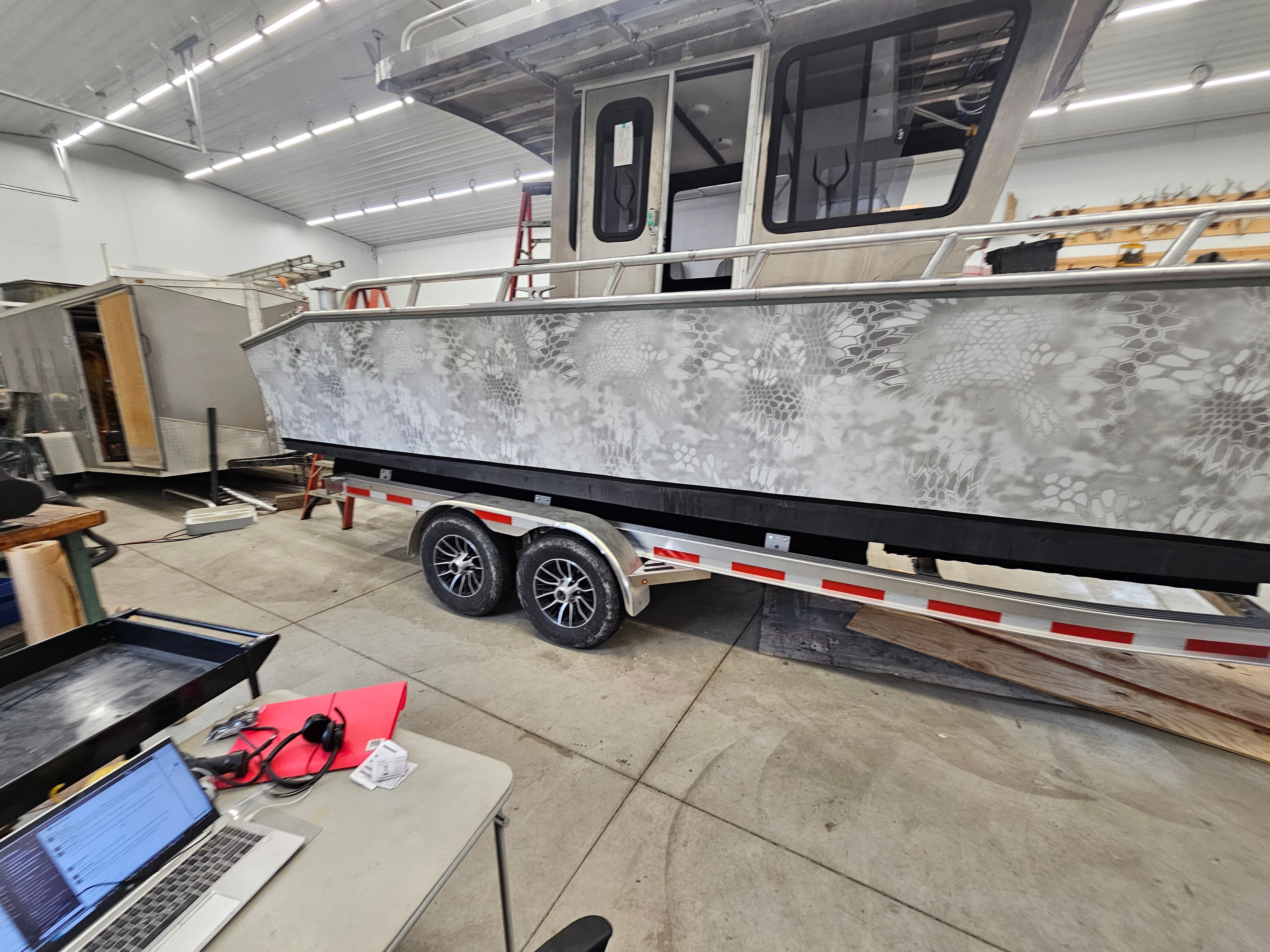 Custom camouflage boat wrap in the workshop