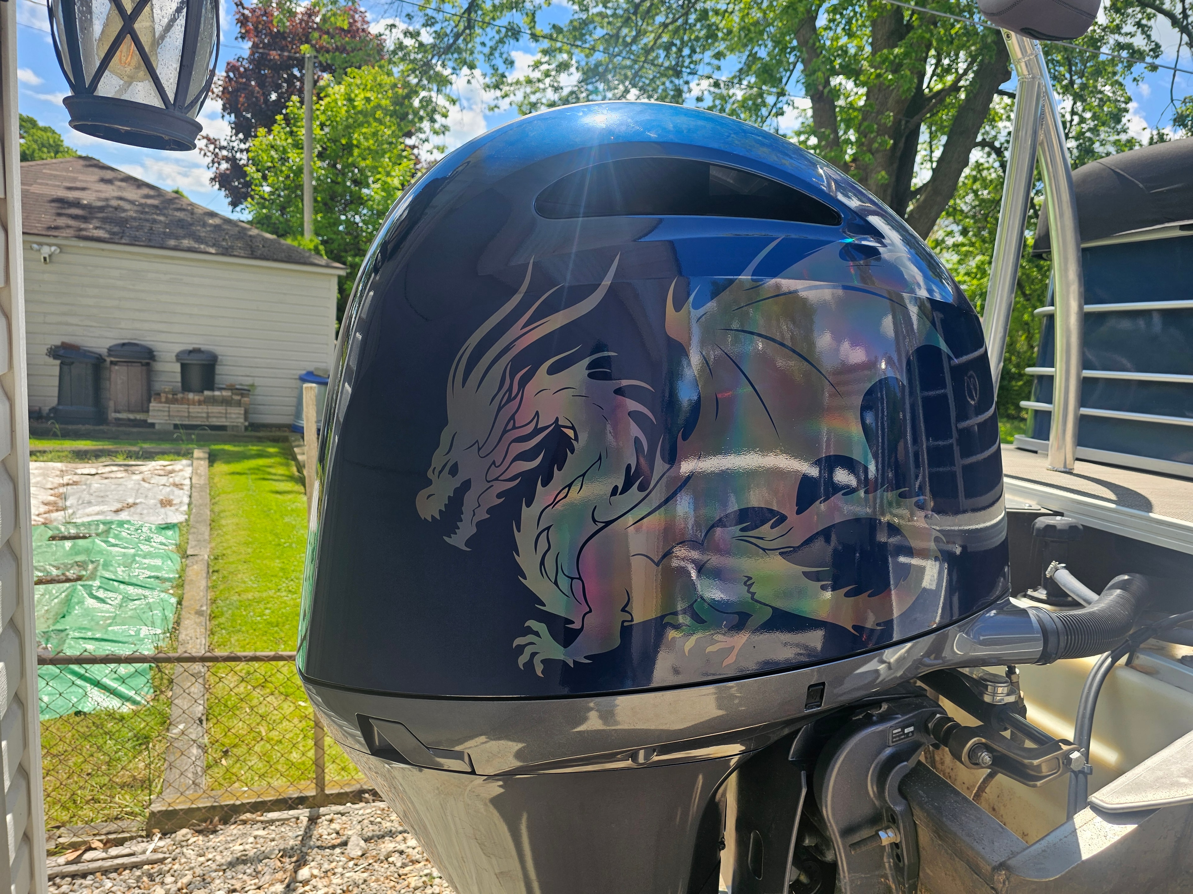 Custom dragon graphic on a blue boat motor