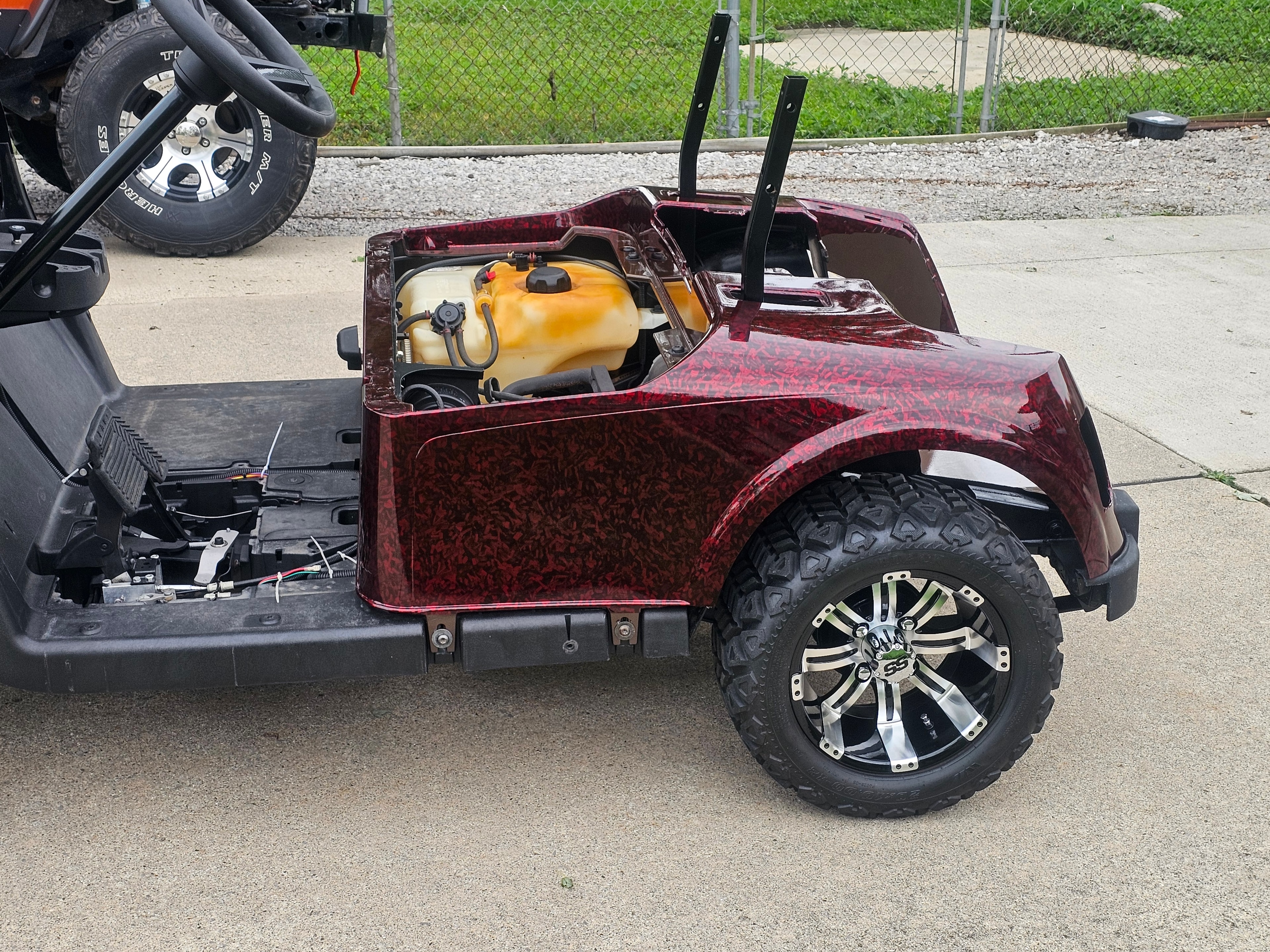 Rear view of a maroon custom golf cart wrap
