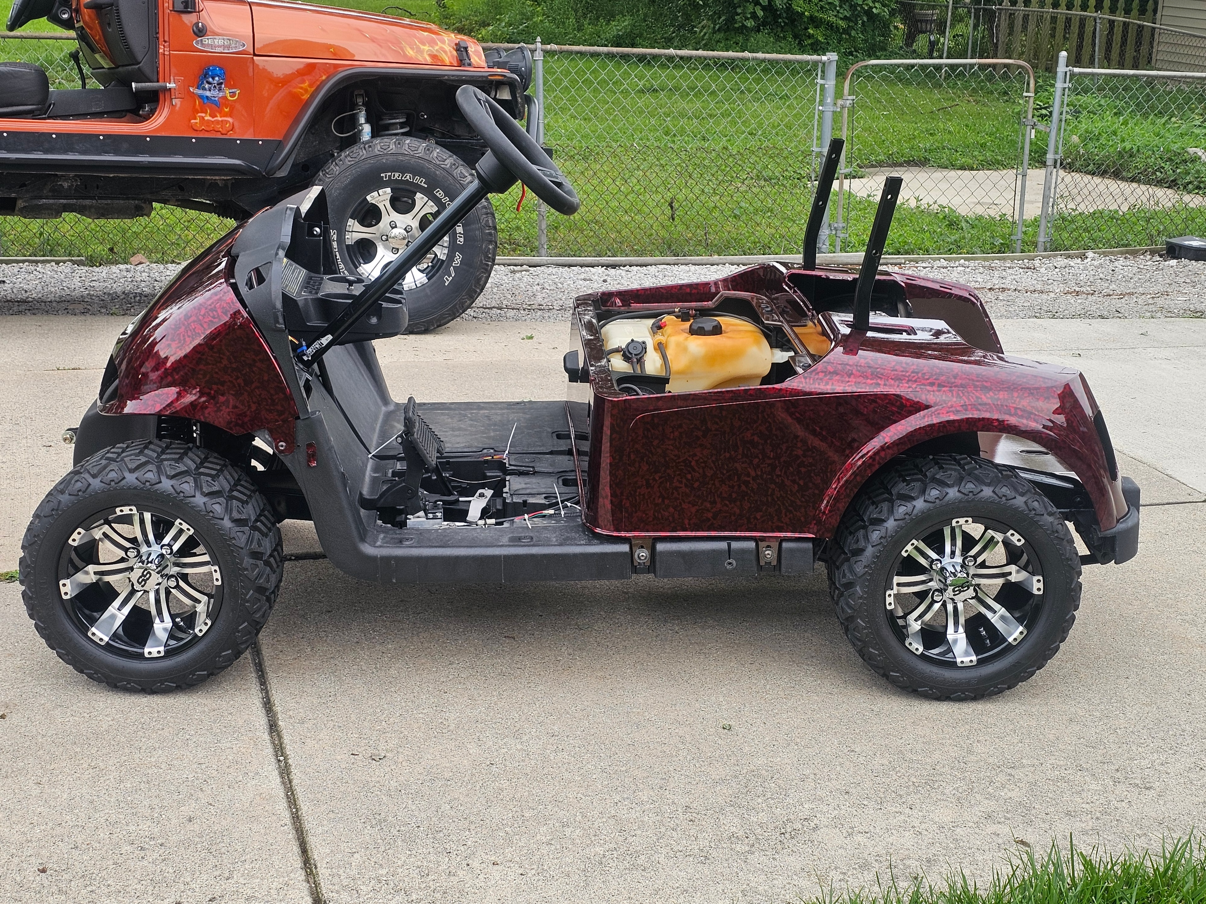 Side view of a maroon custom golf cart wrap