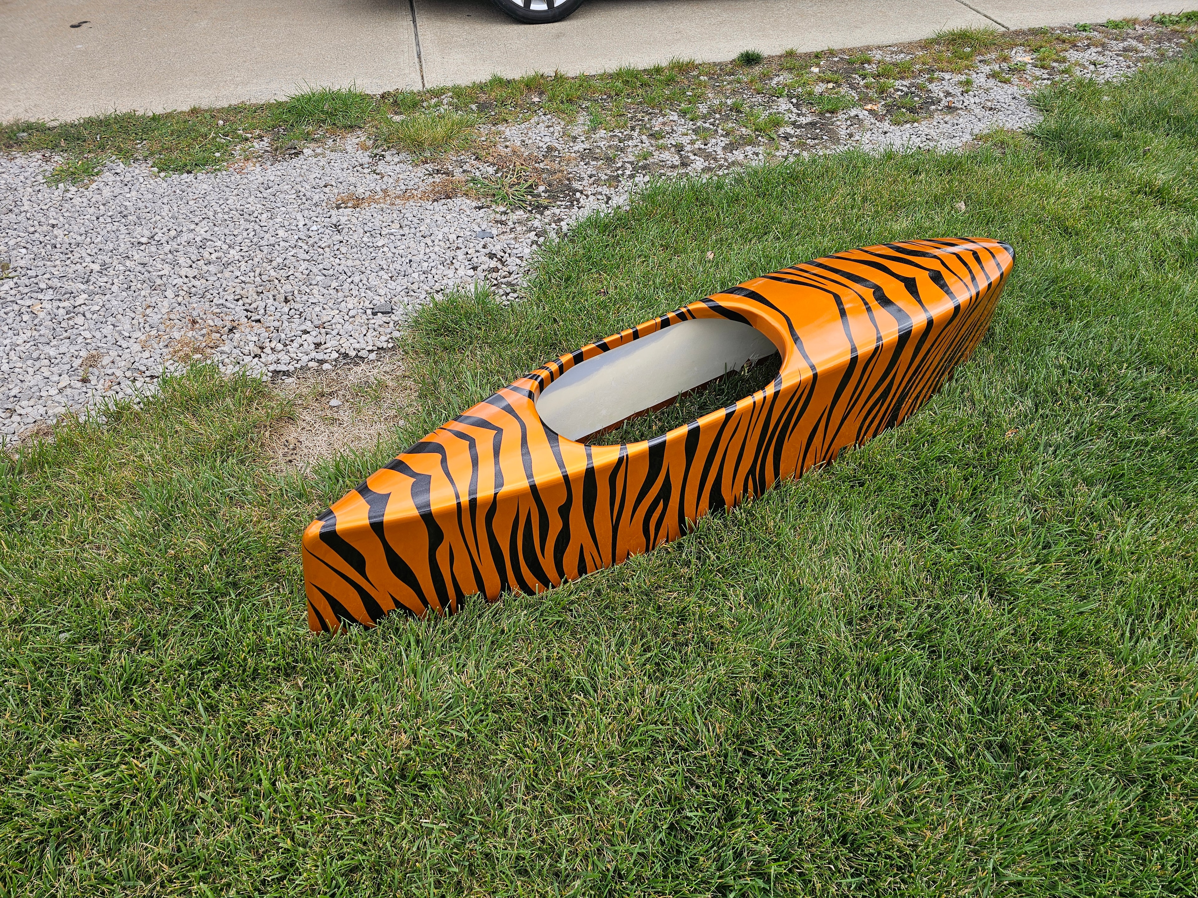 Custom tiger-stripe graphics on an orange kayak