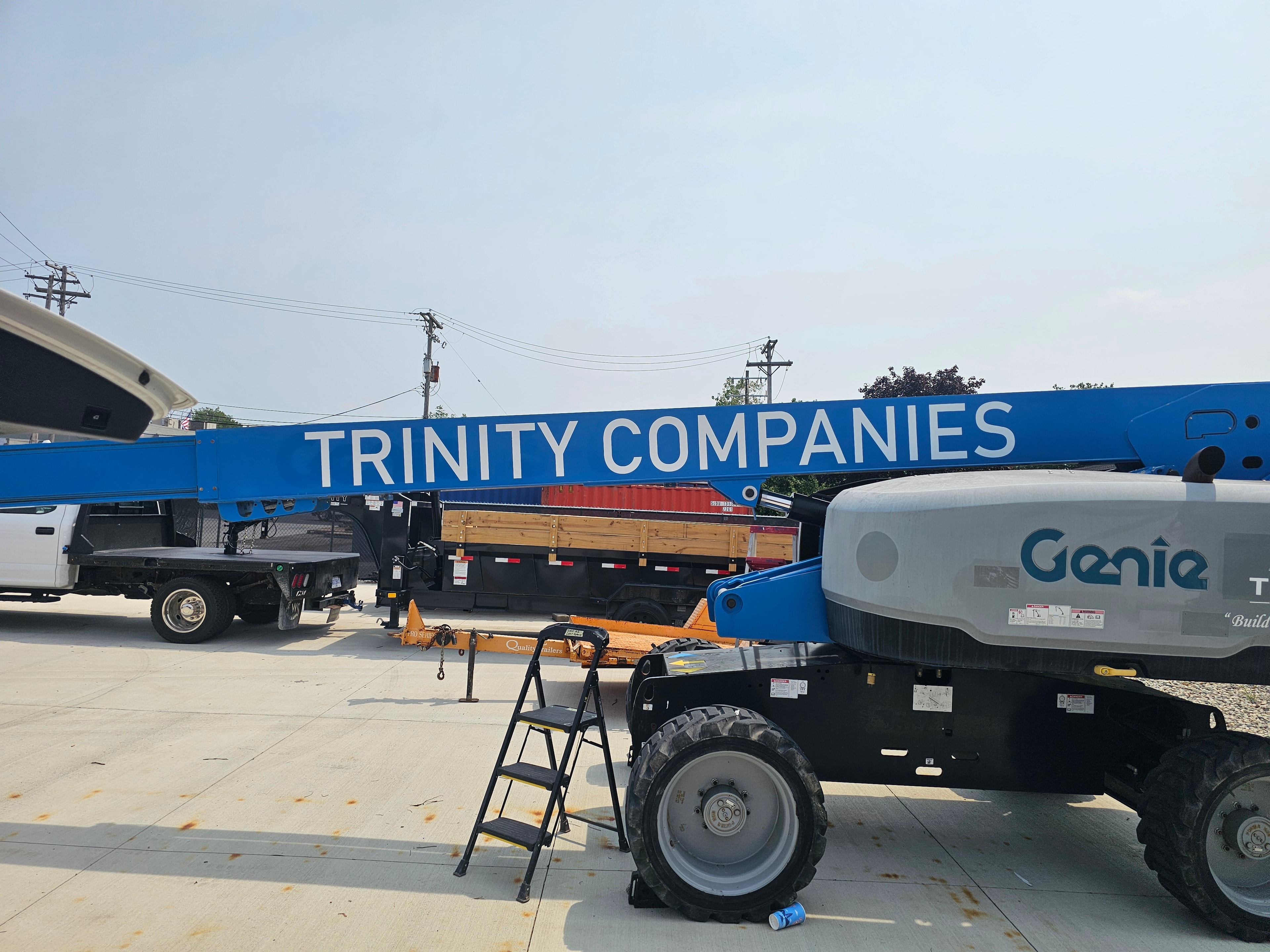 Large-format Trinity Companies lettering on a boom lift
