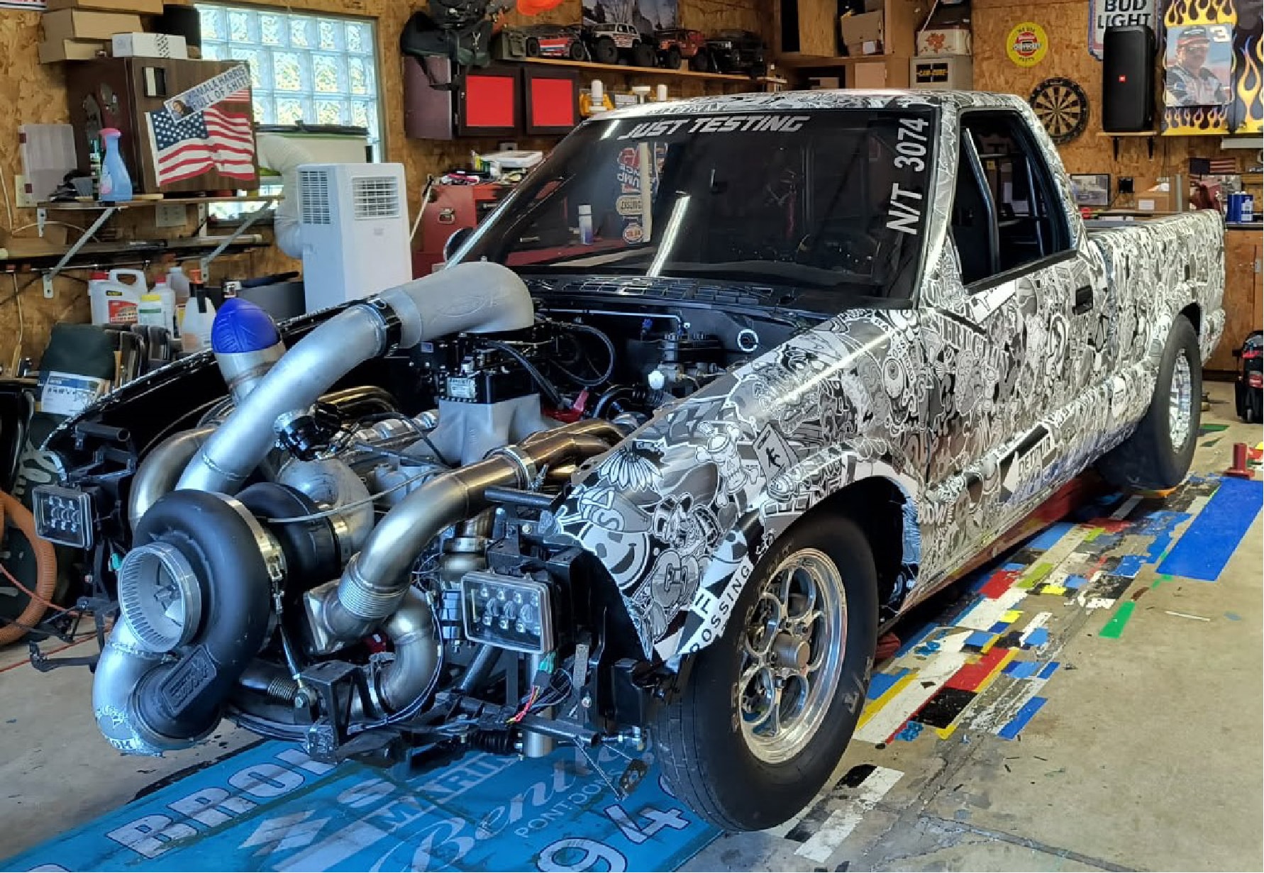 Custom illustrated vinyl wrap on a turbocharged race truck